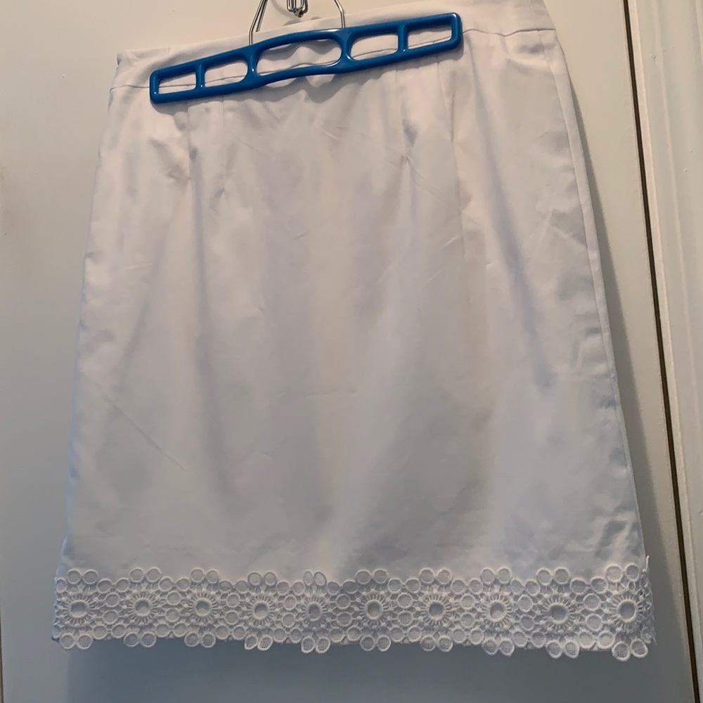 Above knee white skirt.